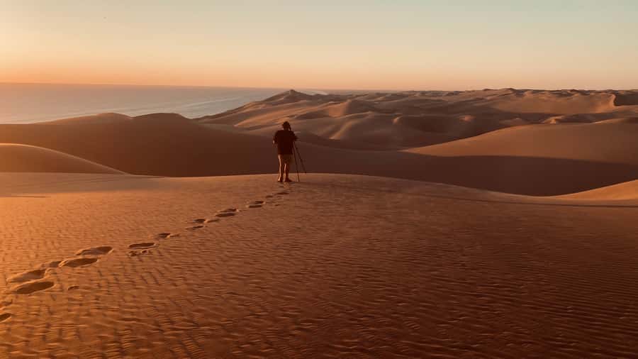 Walvis Bay: Sandwich Harbour Sunset Photography Tour - The sunset itself, with dunes on one side and ocean on the other